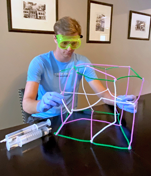 student completing science lab at home