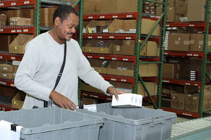 Worker filling bins at our Rock Creek distribution center